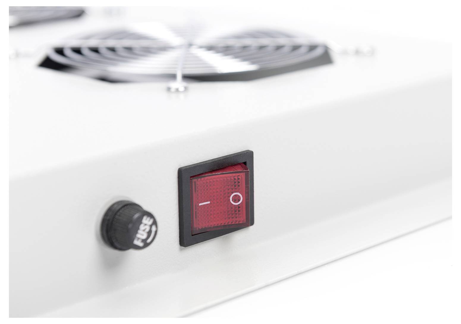 A close-up of a white electronic device shows a red power switch in the 'on' position next to a fuse indicator.