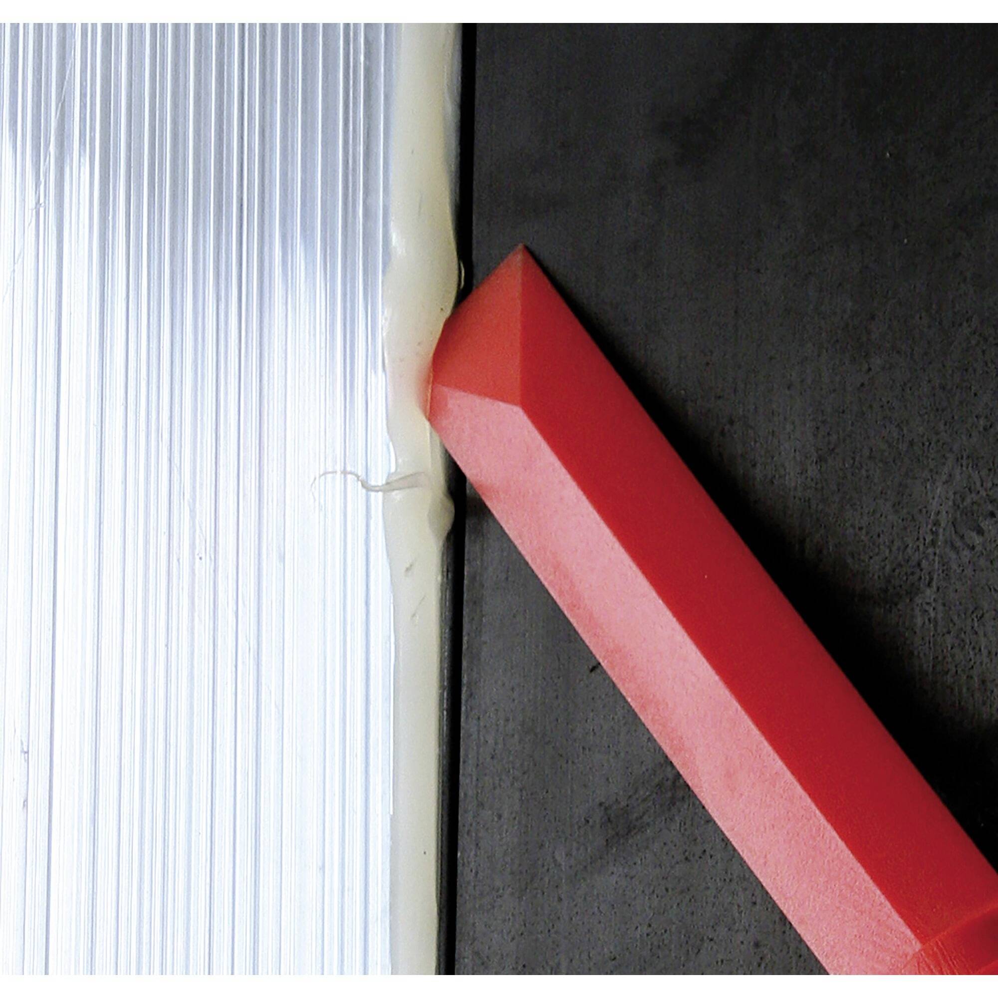 Red wedge for levelling between silver and black surfaces.