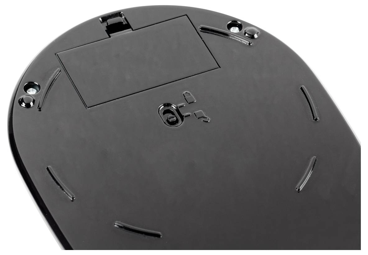 Back of a black computer mouse with battery compartment, screw holes, and glide surfaces.