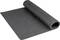 A rolled-up black yoga mat is lying on the floor.