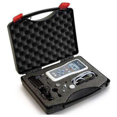 An open black case with foam lining reveals a measuring instrument with a display and buttons, along with accessories such as cables and a battery.