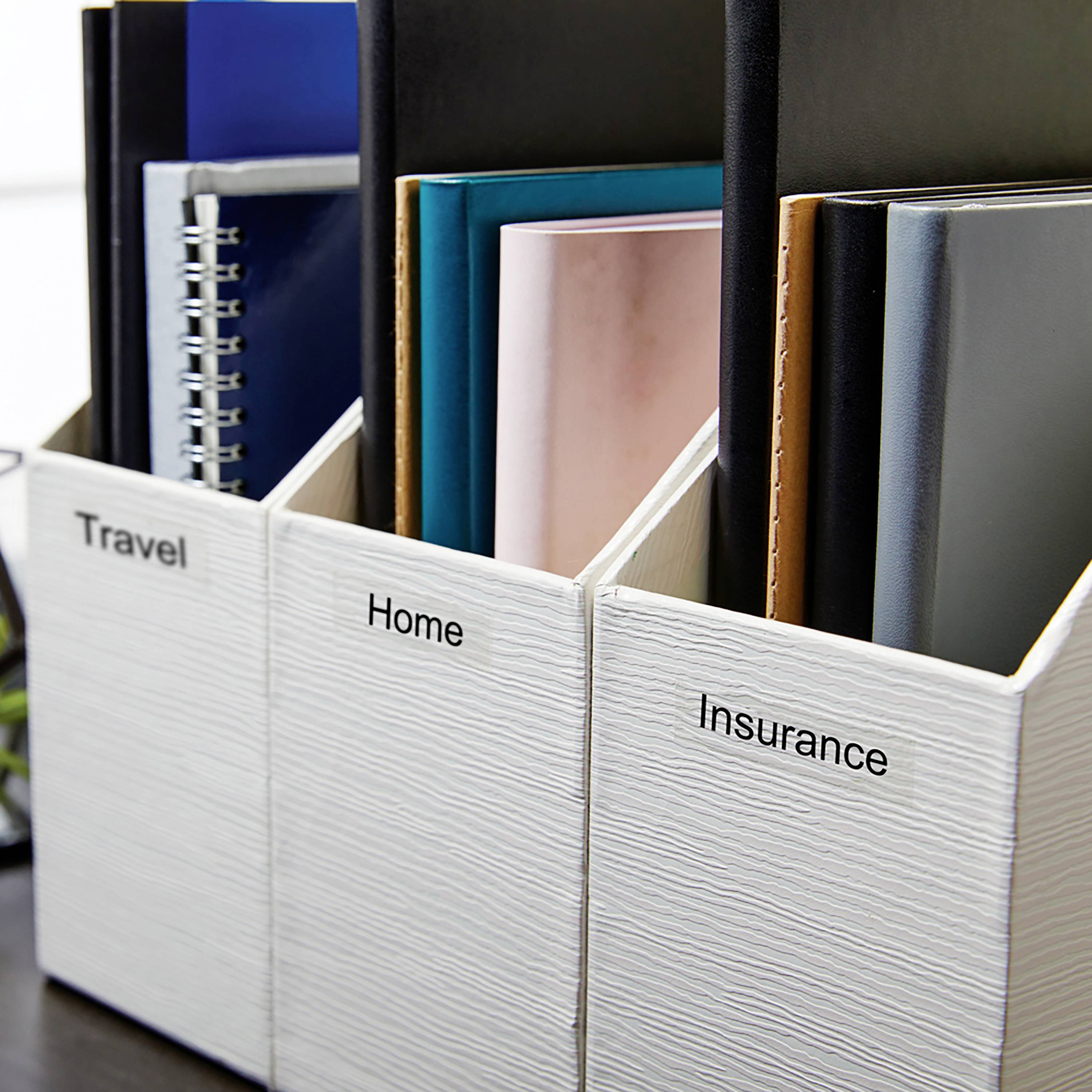 Three white magazine holders on a table, labelled 'Travel', 'Home' and 'Insurance'. They contain various folders and documents.