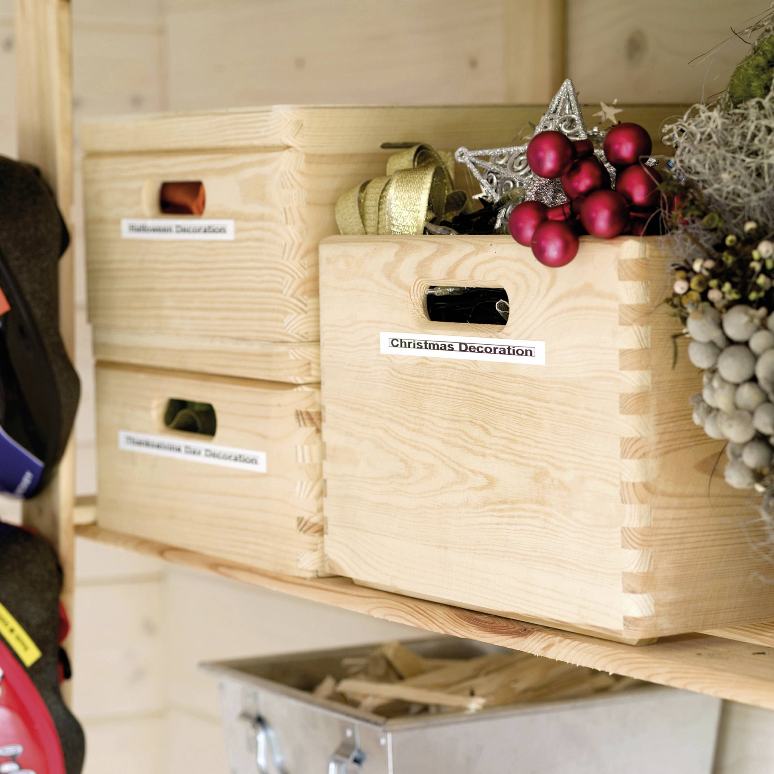Three wooden boxes on a shelf. One is labelled 'Christmas Decoration' with Christmas decorations inside, the other 'Halloween Decoration'.
