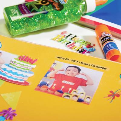 A birthday album with a photo of a child celebrating, decorations and the date '24 June 2001 - Brian's Birthday'.