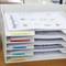 'A filing compartment with various labels such as 'Homework', 'Exams' and 'Tests', filled with documents and work materials.'