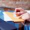 A person opens a paper envelope.