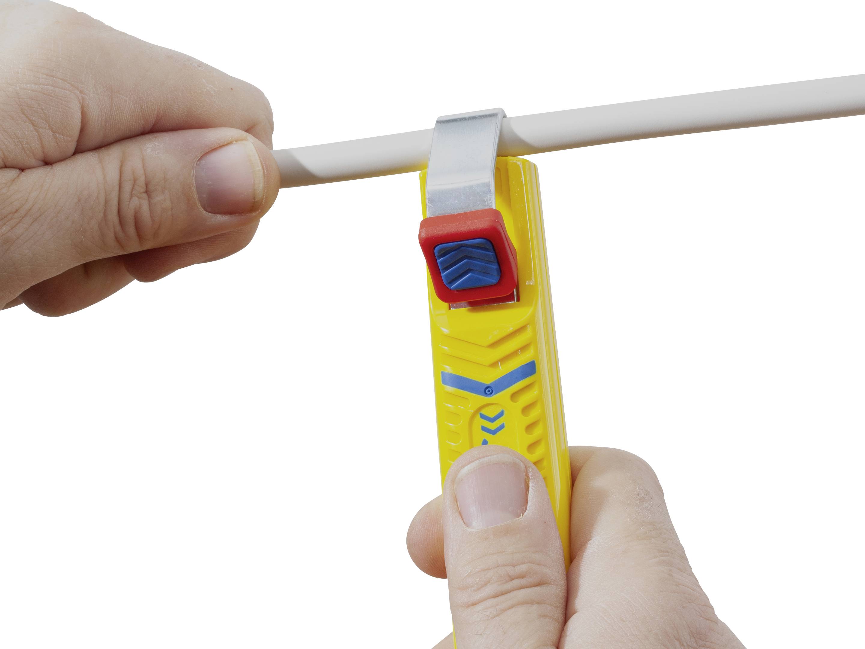 A person is using a yellow cable stripping tool to remove the insulation from a white cable.
