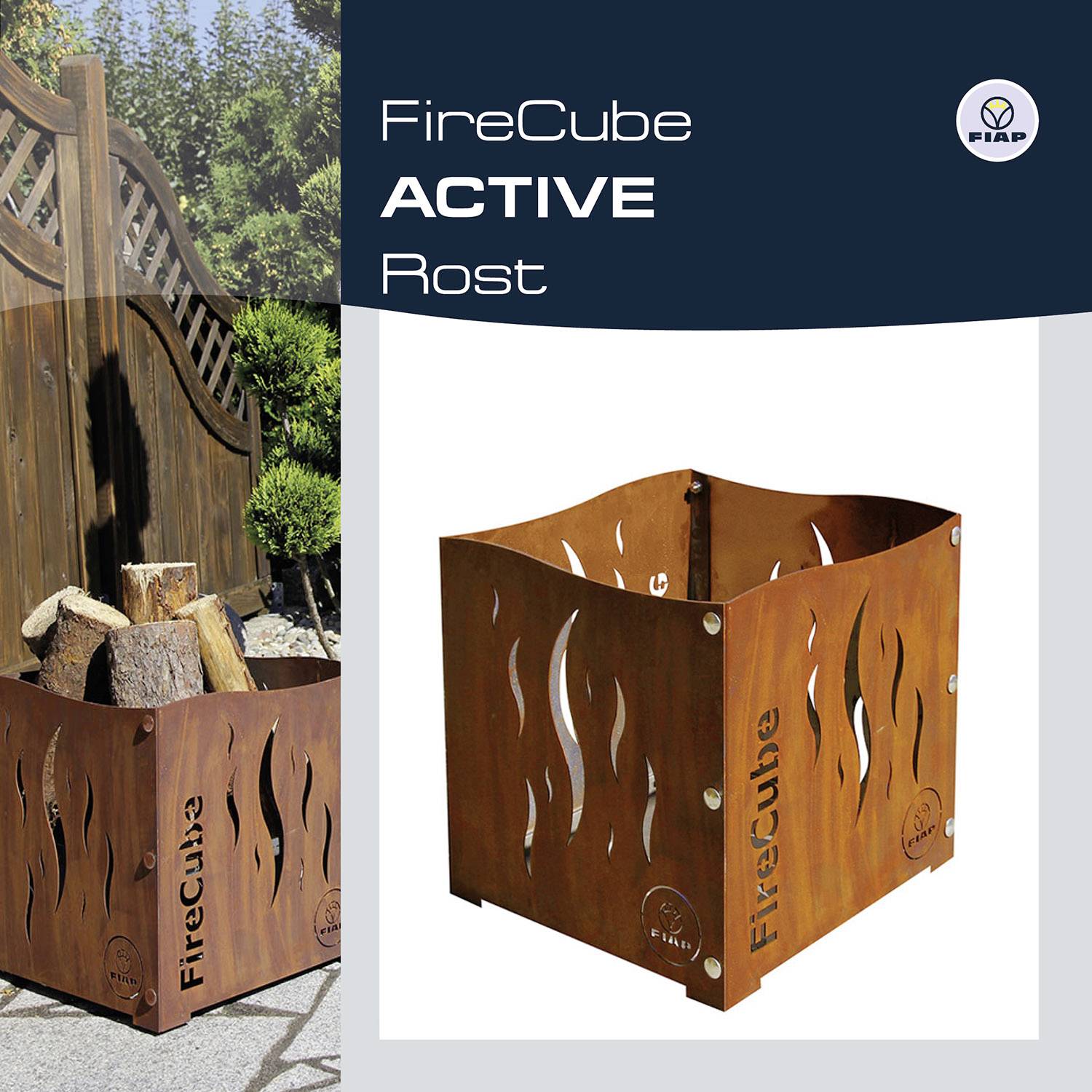 Pictured is a square fire basket made of rusty metal with cut-out flame motifs and the inscription 'FireCube'. Stacked wood is visible in the background to the left, in front of a garden fence.