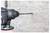 Close-up of a power drill with a masonry bit drilling into a concrete wall.