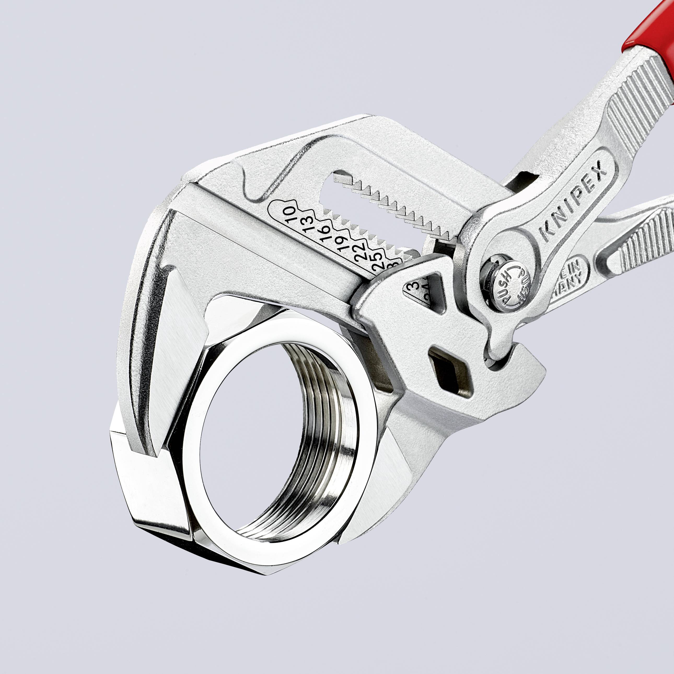 An adjustable spanner with a red handle grips a large hexagonal nut. It demonstrates its gripping function and adaptability.