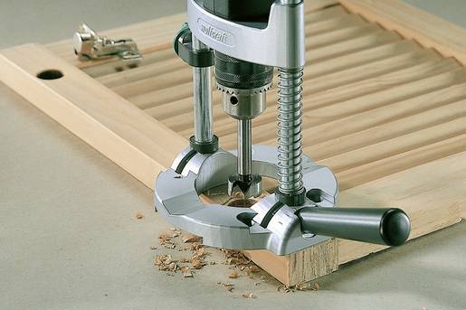 Router machining a wooden board, wood shavings visible. Primarily used for carpentry or furniture work.