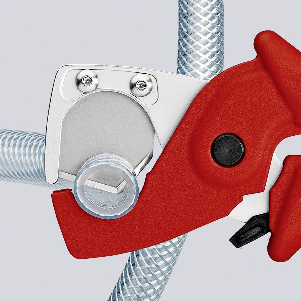 A red pipe cutter is cutting a transparent, braided pipe. The tool is metallic and gripping firmly.