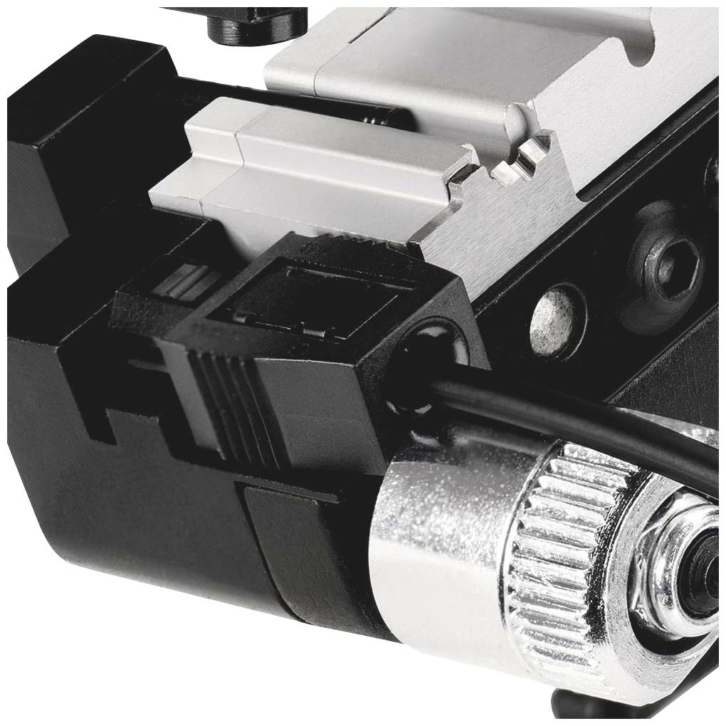 Close-up of a mechanical device with a screw and metal parts used for precision work on machines or tools.