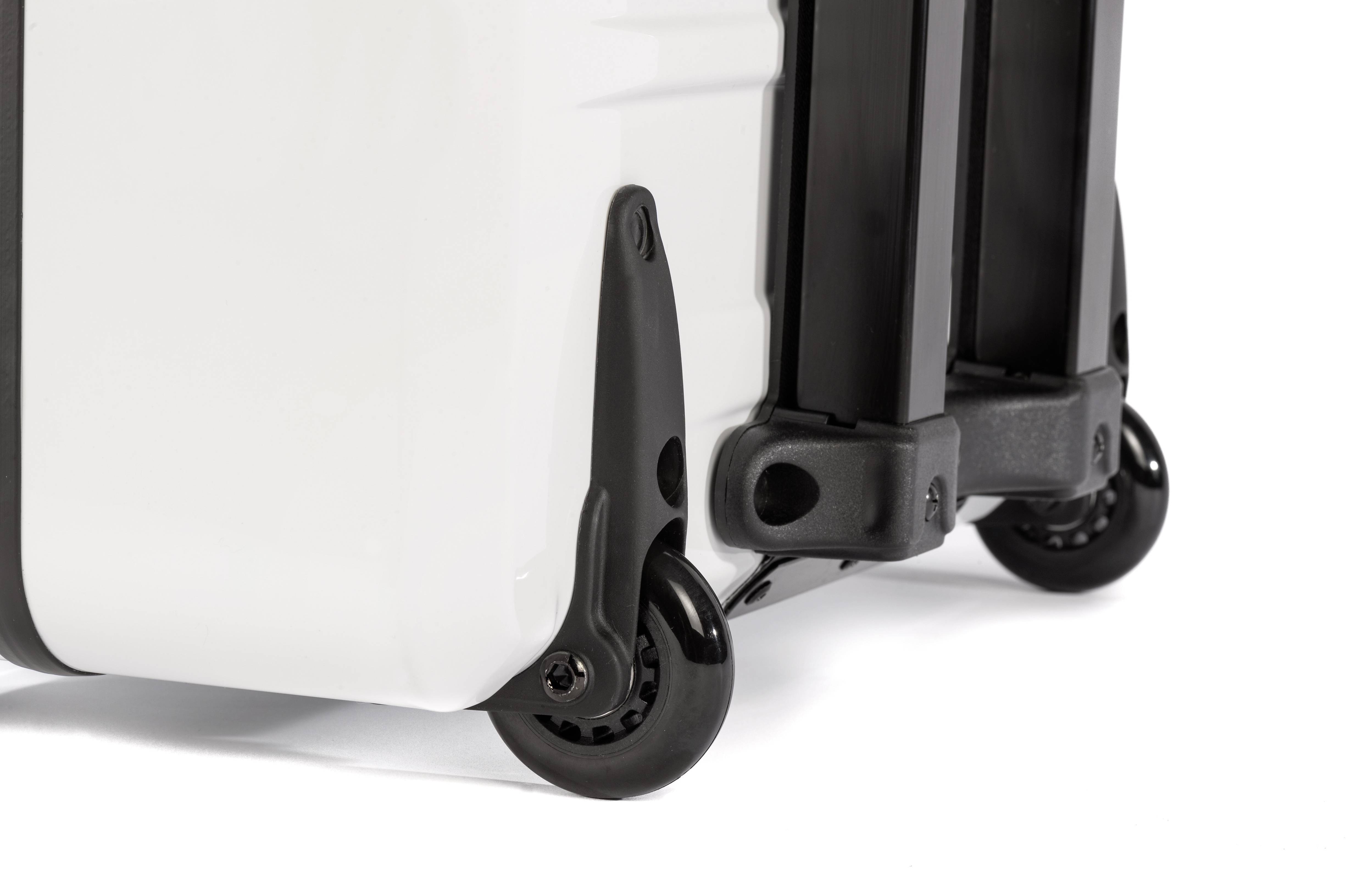 Close-up of the wheels of a white, high-quality suitcase on a smooth surface.