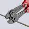 A red bolt cutters slice through a thick steel cable.