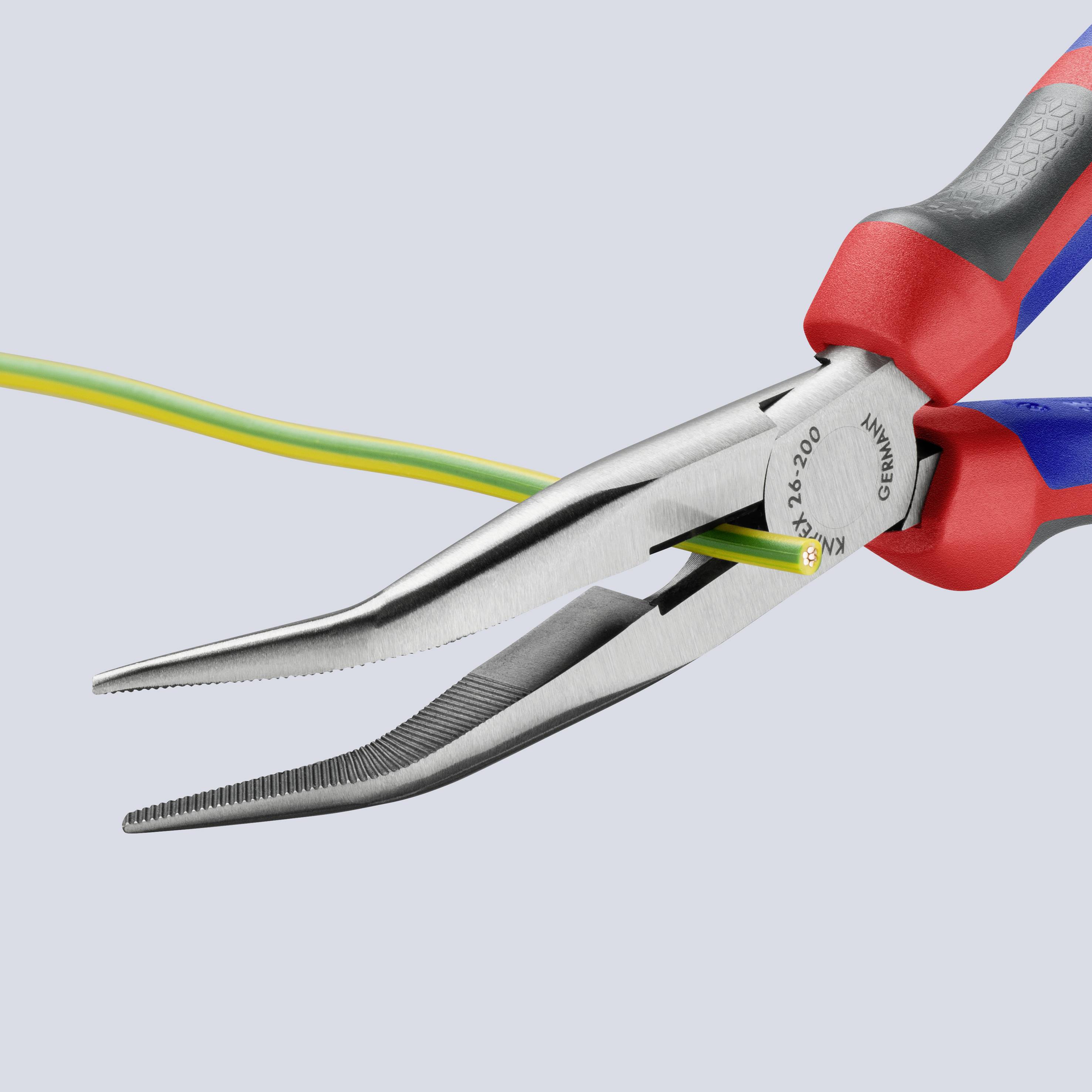 Two red and blue flat pliers are holding a yellow and green cable. The background is a solid light grey.