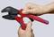 A hand is holding a red and black crimping pliers by the brand 'KNIPEX', model 'MultiCrimp'.