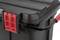 Black plastic container with red caps and handle, suitable for tool storage or transport when securely closed.