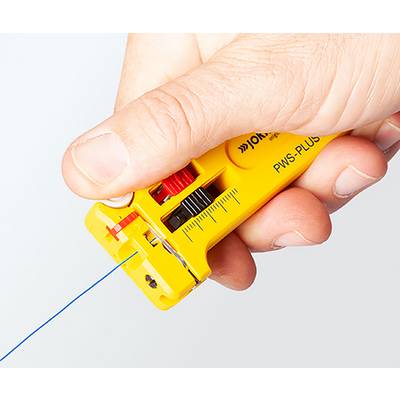 A hand holding a yellow wire stripping tool, partially stripping blue wire, with measurement markings on the tool's surface.