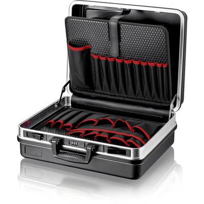 An opened, black briefcase with red interior compartments and slots for organising items, placed on a glossy surface.
