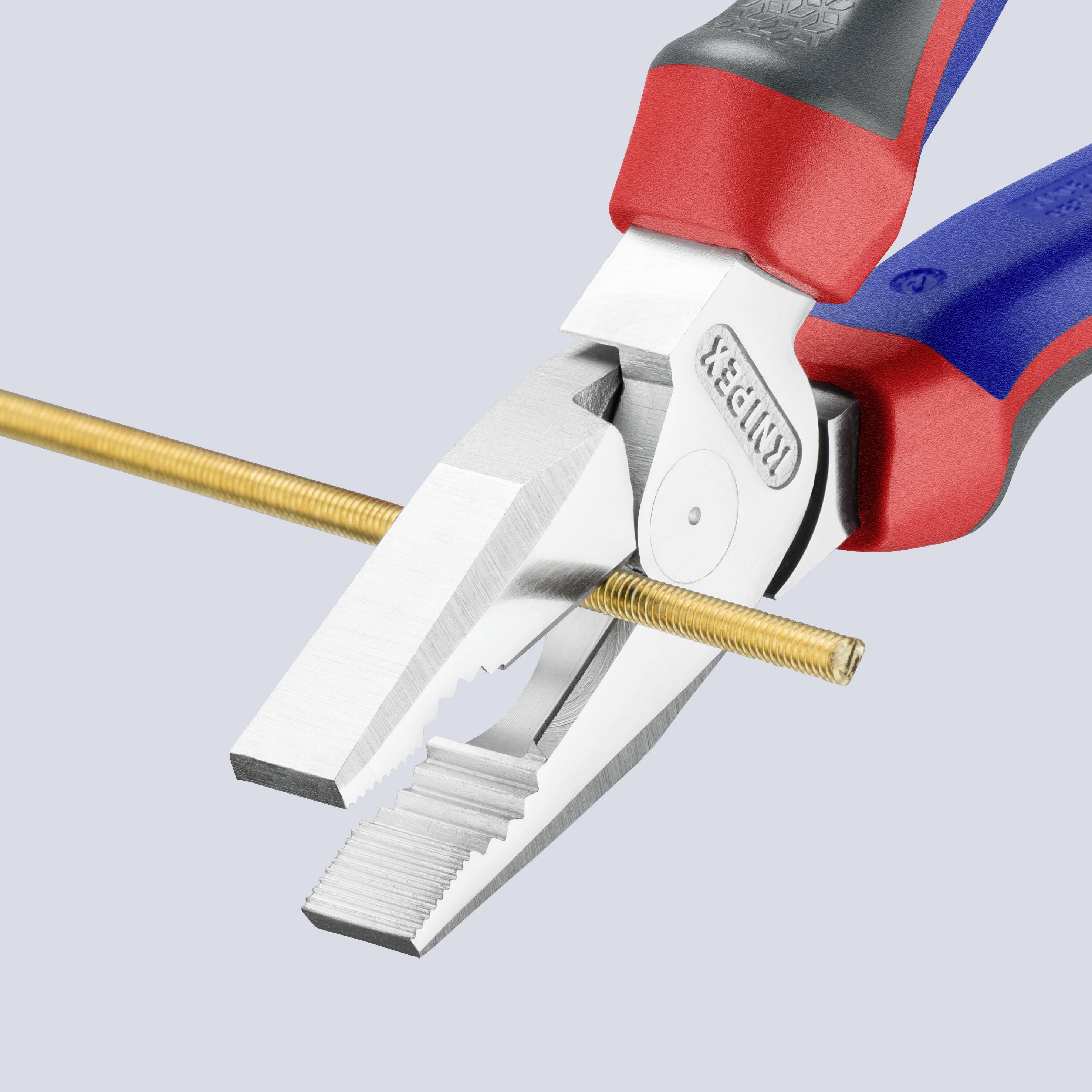 A pair of pliers cuts a thin, gold-coloured wire. The pliers have red and blue handles and a strong metal blade.
