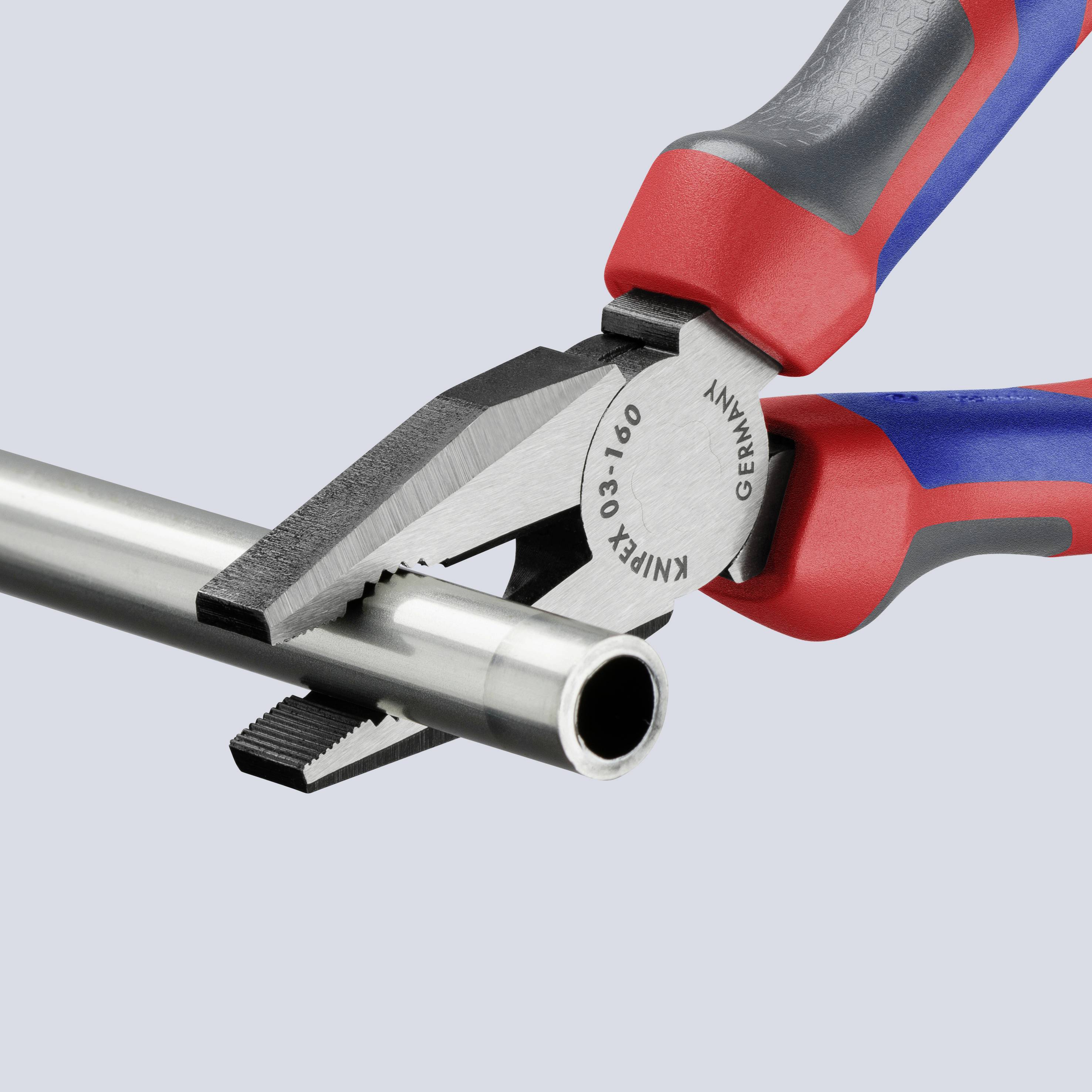 A red and blue pliers cuts through a metal pipe.