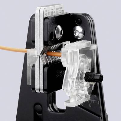 A tool precisely cuts an orange cable. Black blade holder and transparent cutting device with scale indicator.