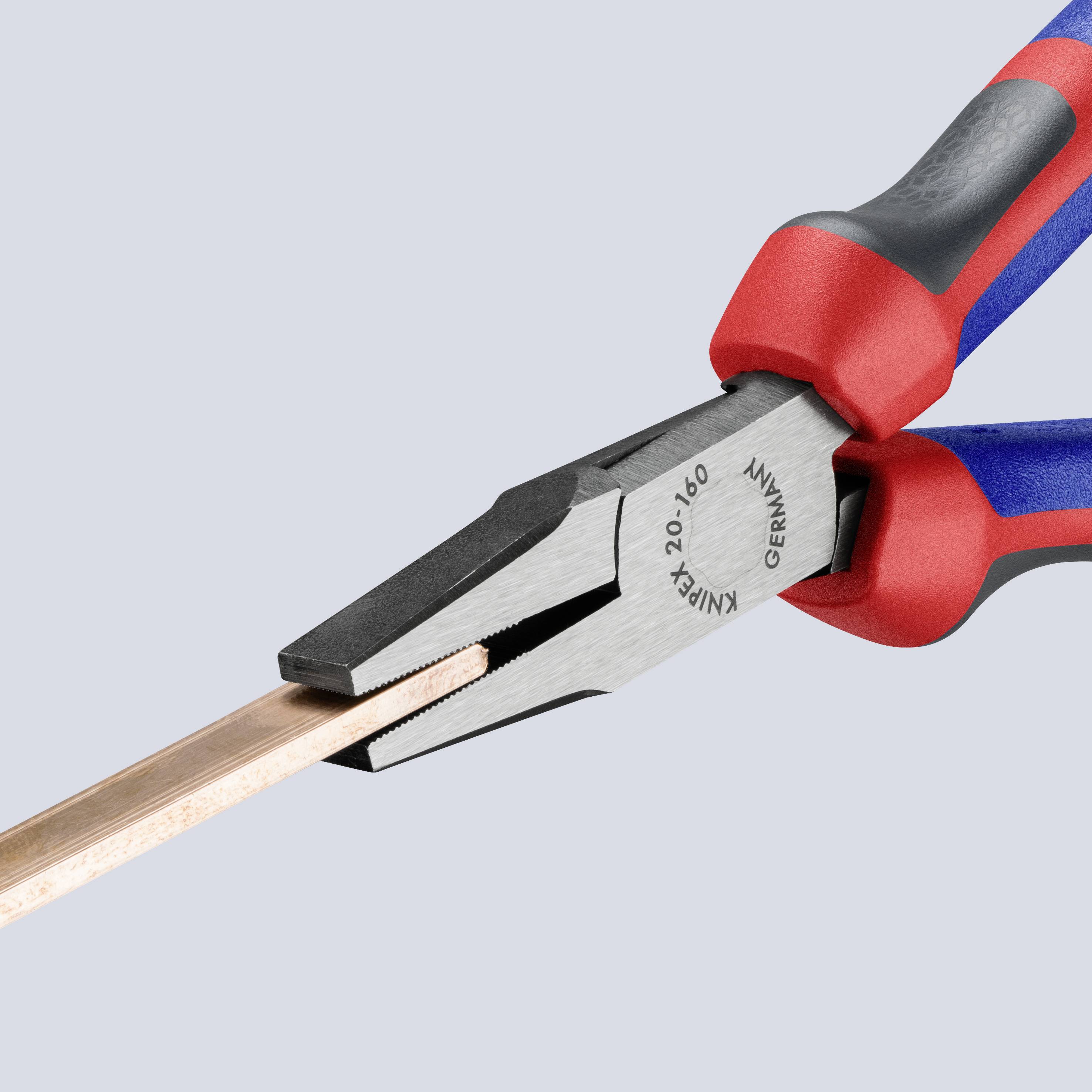 A red and blue combination pliers cuts through a copper pipe.