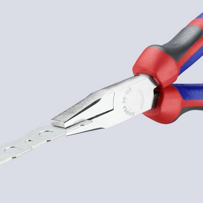 A red and black combination pliers is cutting a perforated metal sheet.