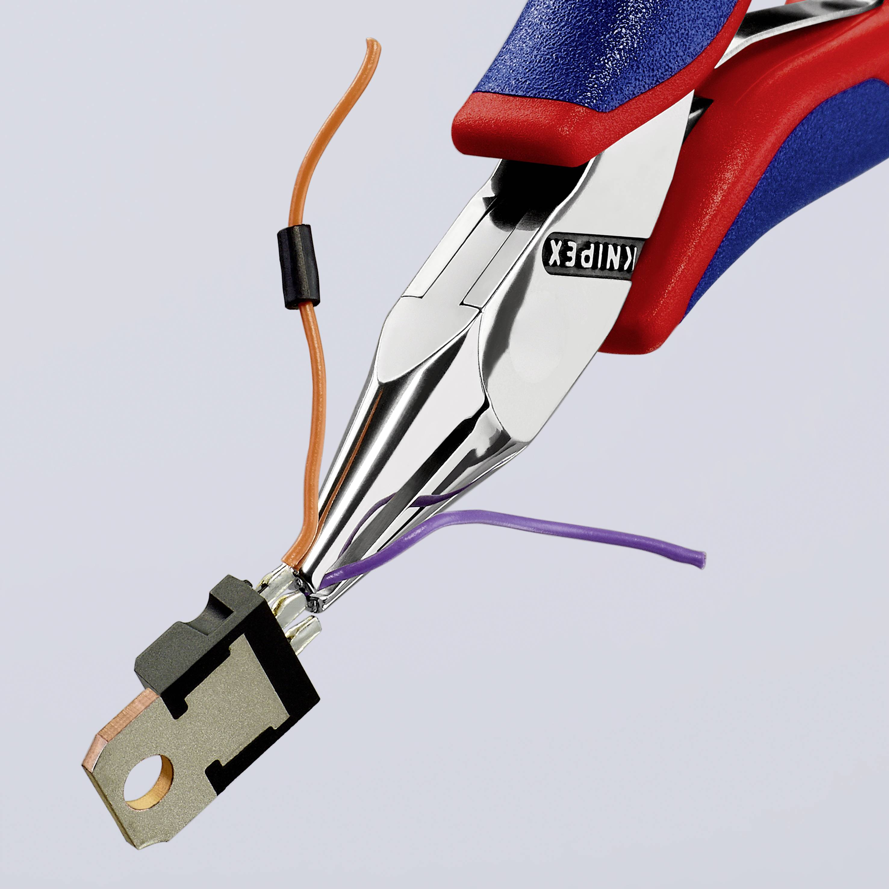 A pair of pliers is holding a small black electrical component with copper wires that are blue and orange insulated.