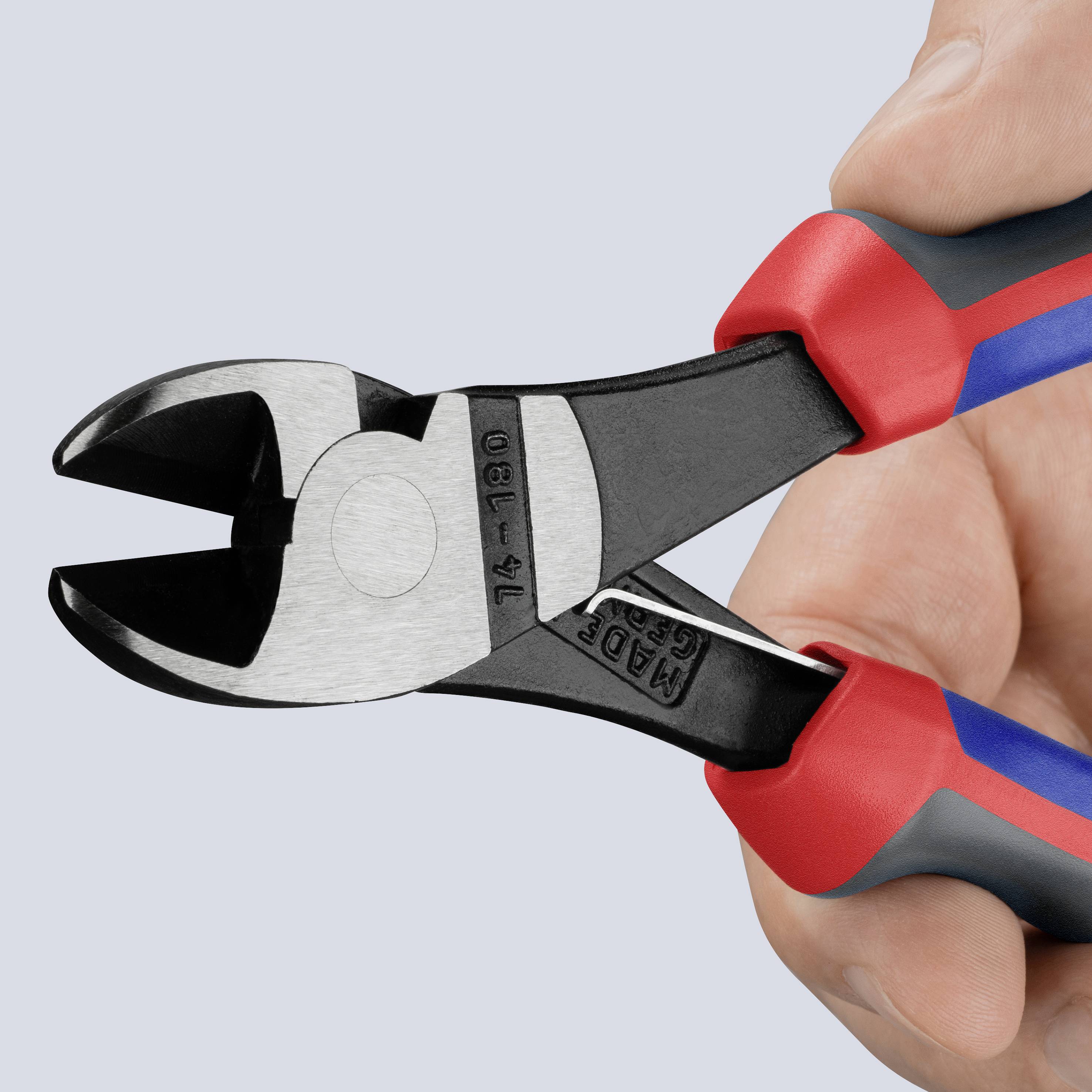 Side cutters with red and blue handles are being held in hand, ready to cut.