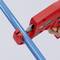 Hand uses a portable, red padlock to secure a blue pipe; a safety precaution to prevent unintended opening.