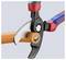 Pliers with a red and blue handle cutting an orange cable.