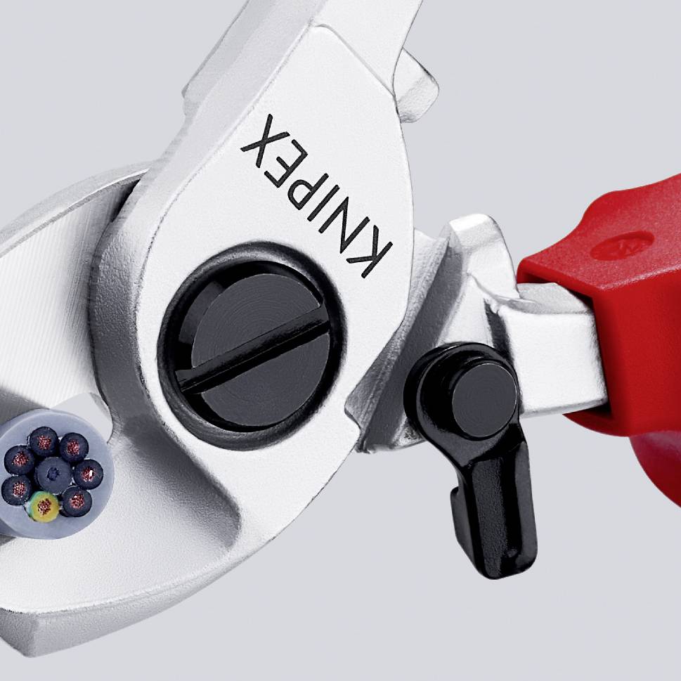 Close-up of a cable cutter cutting through a cable. The scissors are marked with the inscription 'KNIPEX'.
