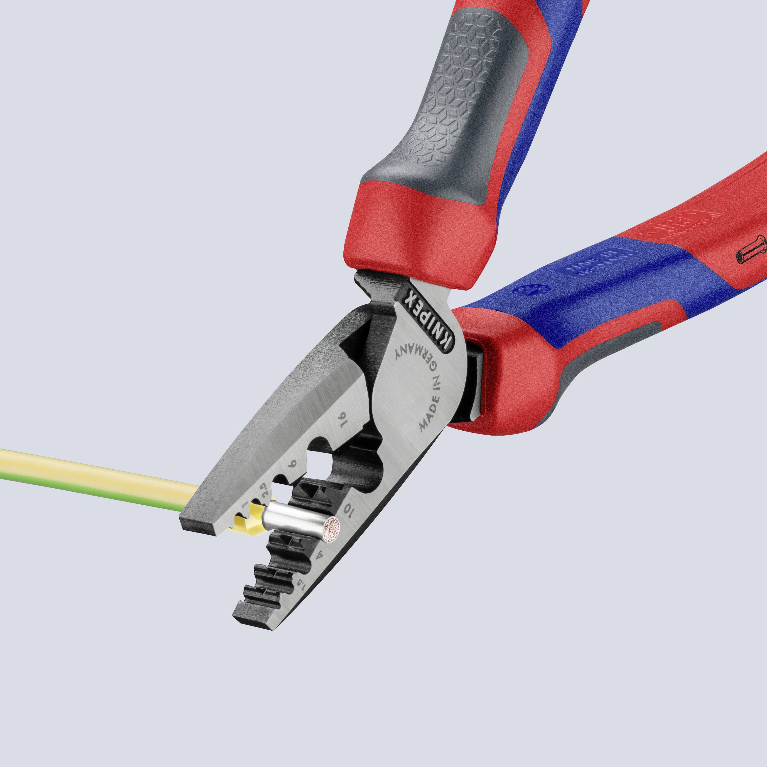 Wire strippers are holding a yellow cable. The handle is red and blue and ergonomically designed. Brand name visible on the pliers.