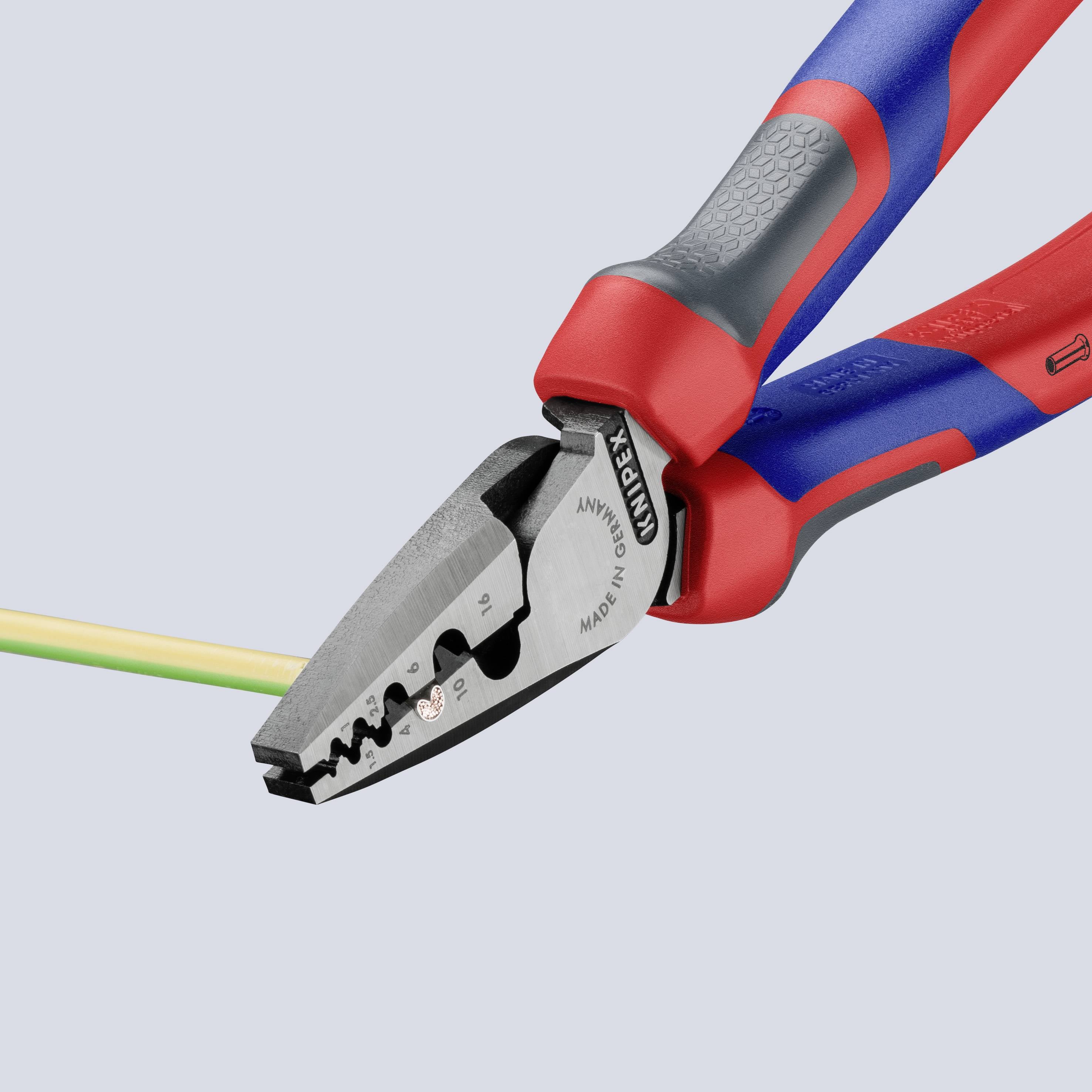 A red and blue combination pliers cuts a multi-coloured cable. It is shown in close-up, emphasising precision and functionality.