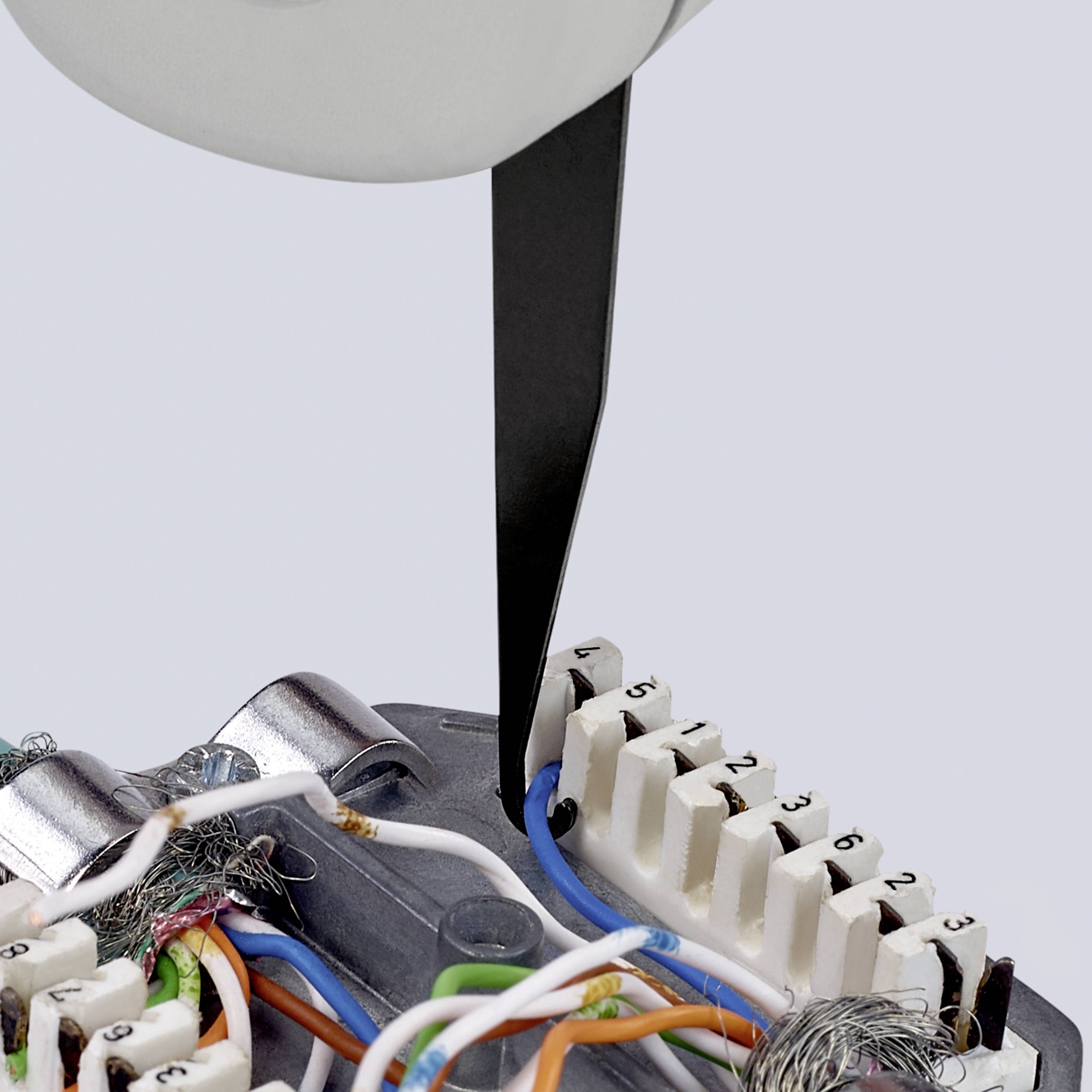 A tool separates the outer protective sheath of a cable bundle. Wires are visible, which are secured to a plastic connector.