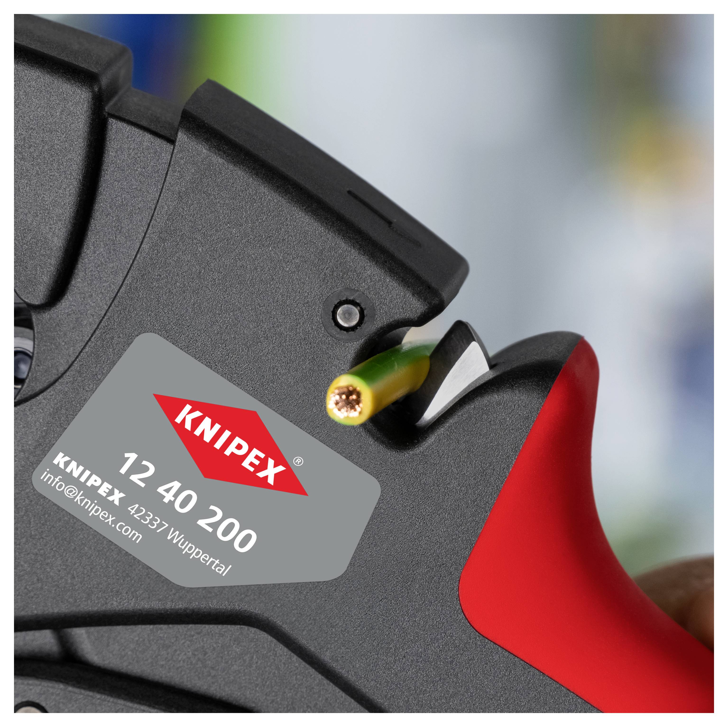 Wire stripping tool held close-up with a partially stripped green wire, revealing copper strands. The tool features a label showing 'KNIPEX 12 40 200'.