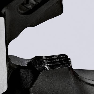 Close-up of a metallic object with a smooth, slightly curved surface and a black plastic component beside it.