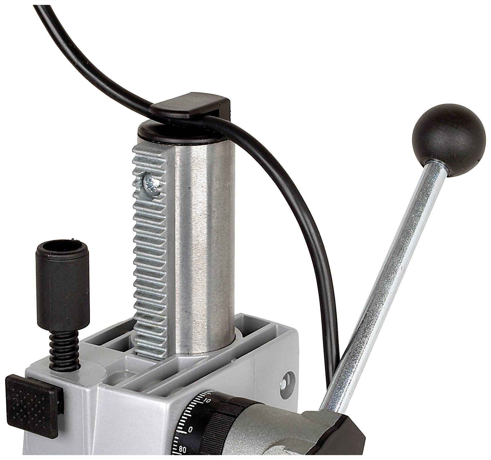 Close-up of a silver machine lever with a black handle. A black cable runs behind it, part of a larger machine.