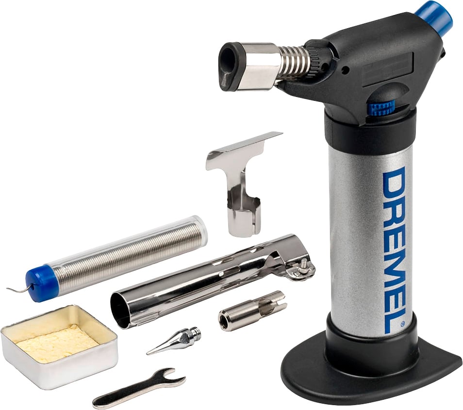 A silver gas burner with accessory parts including a gas canister, a nozzle, a tool, and a demonstration surface; Brand: Dremel.