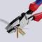 Zange cuts several brown cable ties. Handles are red and blue.