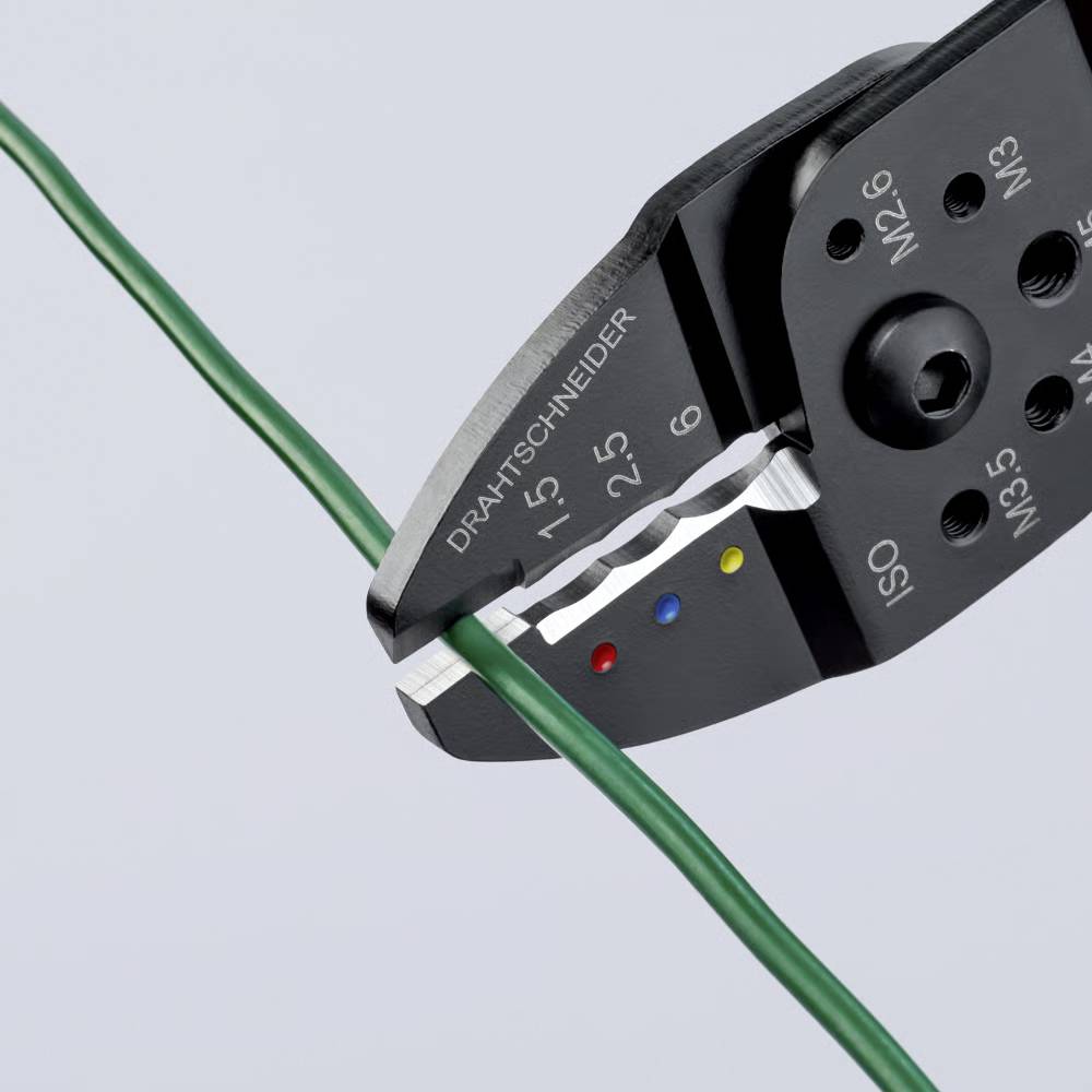 Wire cutter clamping a green wire, showing measurements on the tool.