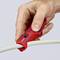 A hand is holding a red cable stripping tool and cutting the insulation of a white cable.