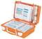 An open, orange first aid kit with various bandages, compresses, and plasters, ready for quick use.