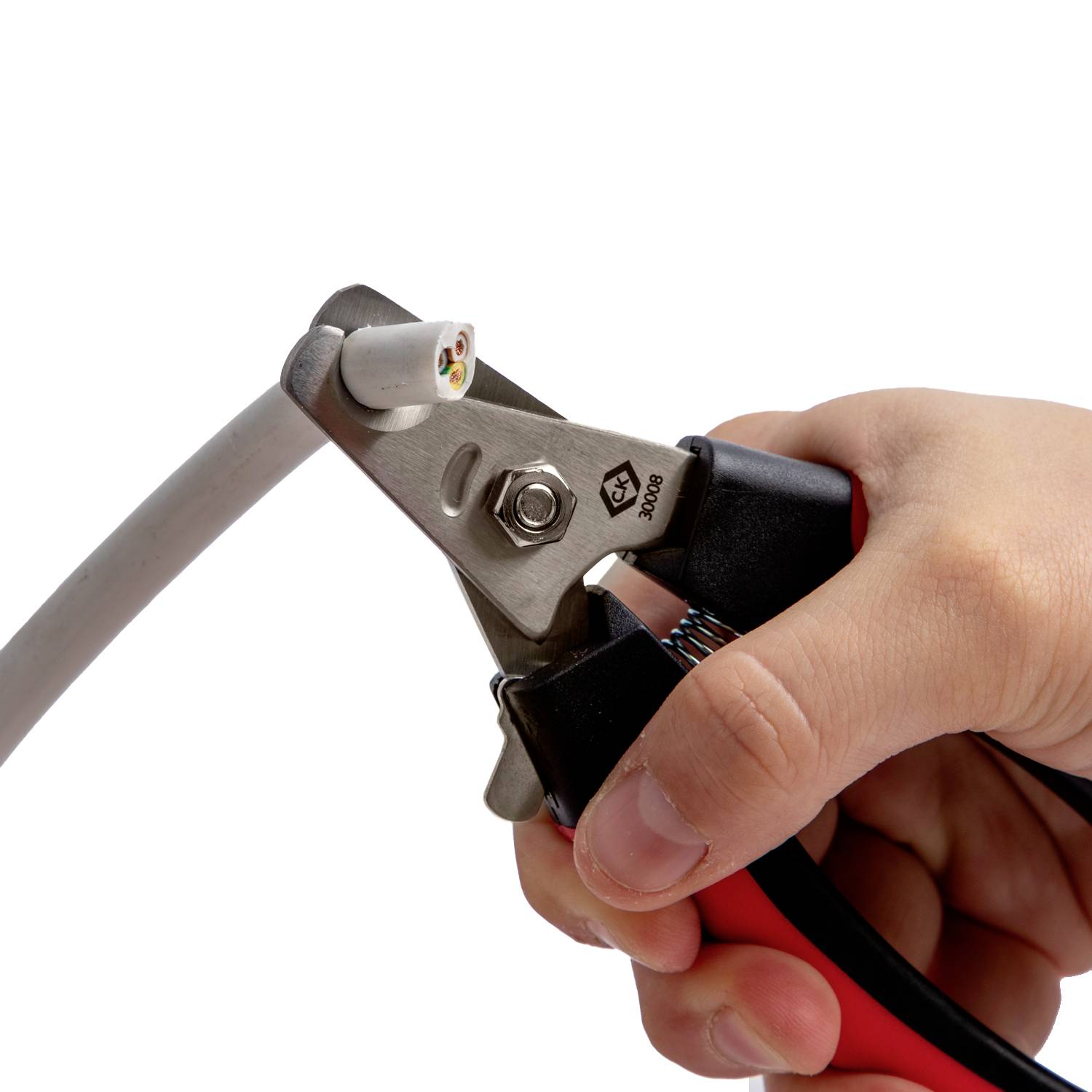 A hand using a cable cutter to trim a coaxial cable, with exposed wires visible. The tool is positioned at the end of the cable.