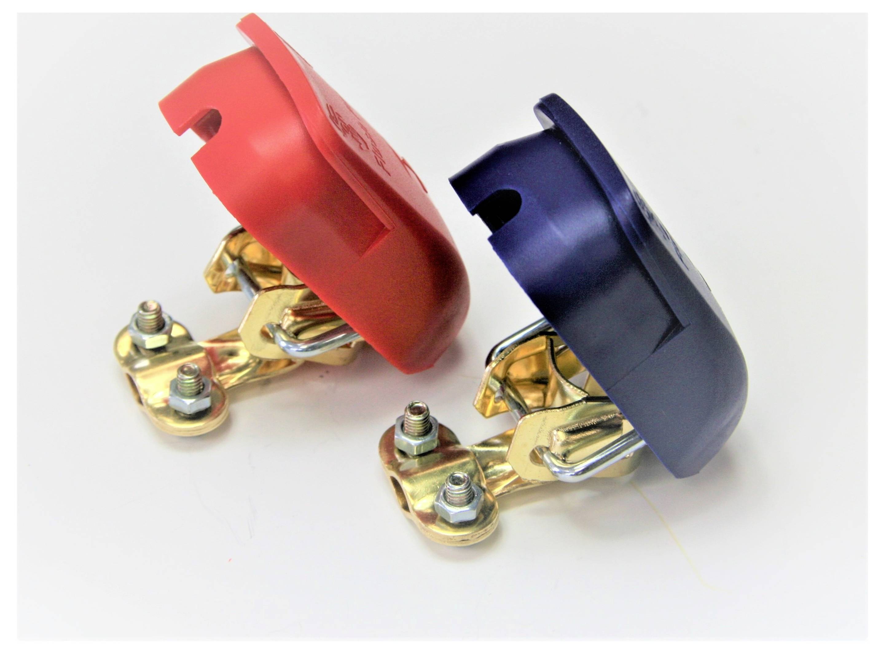 'Red and black battery terminal covers attached to brass connectors on a white background.'