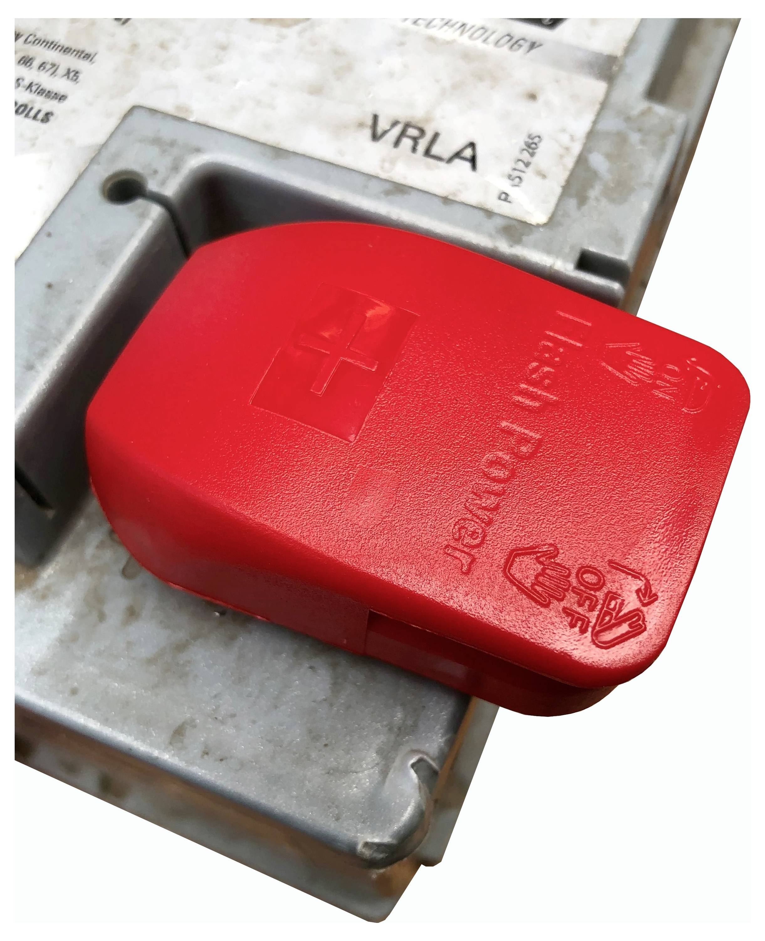 'A red safety switch with "Push Power Off" marked on it, attached to a metal panel. Used for emergency power disconnection.'