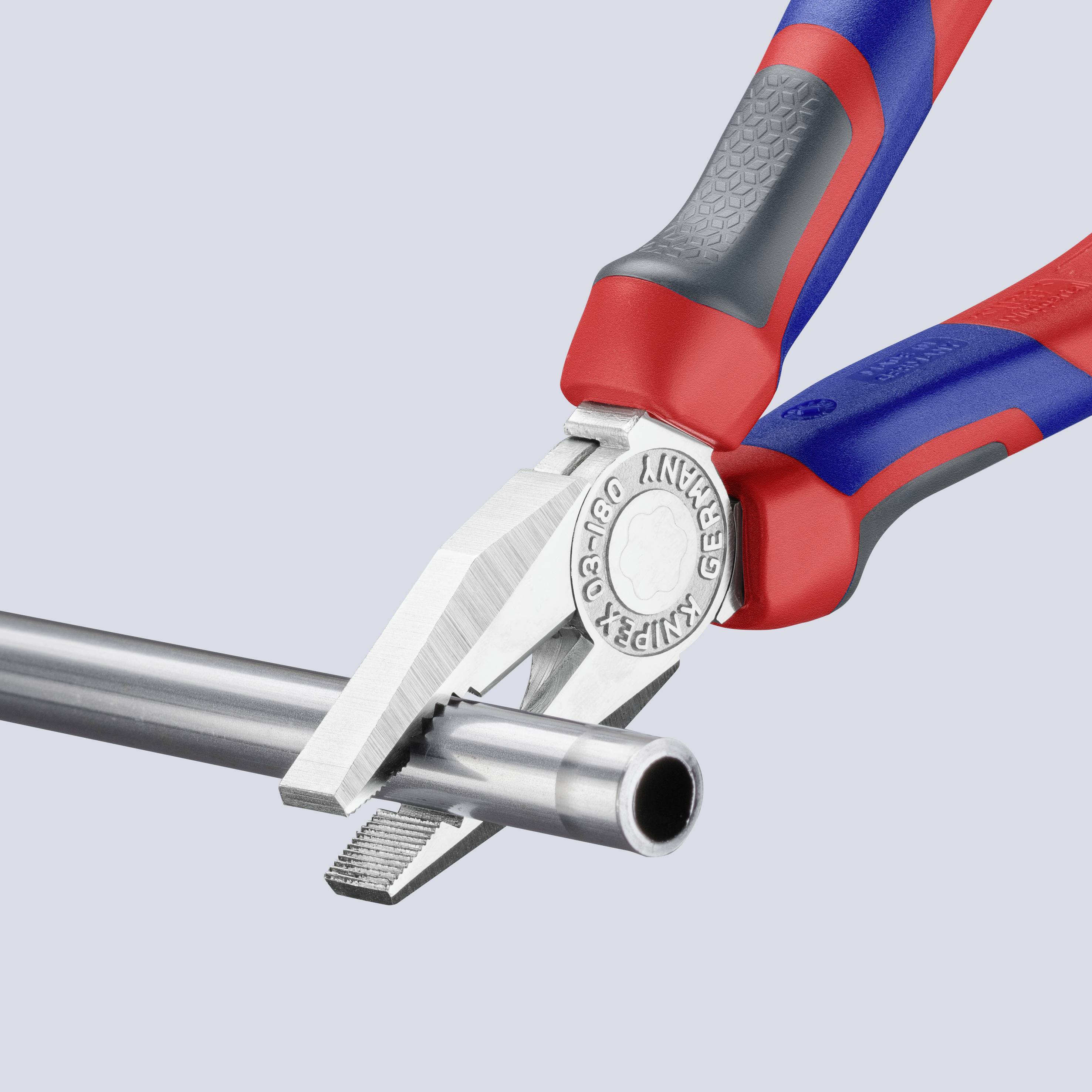 A red and blue pair of pliers cuts through a silver metal pipe. The pliers grip the pipe firmly, ready to slice through it.