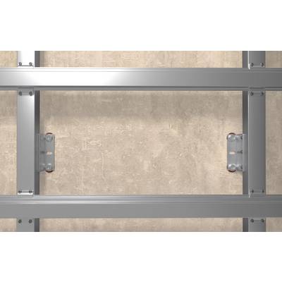 Close-up of a metal wall frame with horizontal and vertical silver beams mounted against a beige concrete wall.